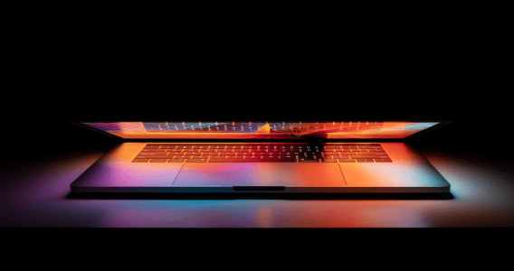Image of a closing laptop with various digital colours