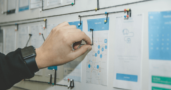 Image of a hand working on a process board