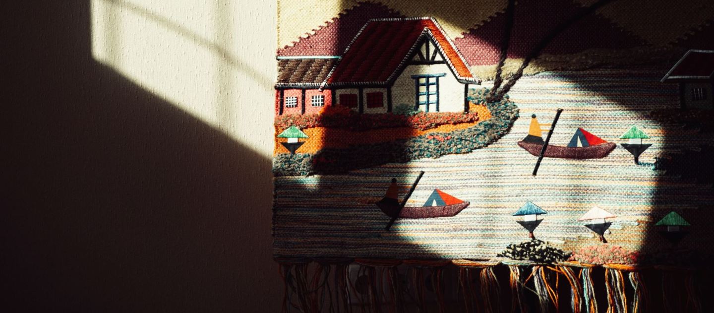 Image of a ships on a lake next to a shoreline. Made as a tapestry