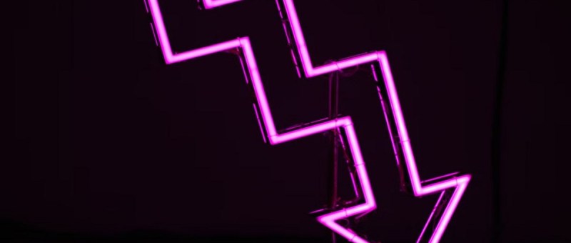 Purple neon arrow light, staggered as it points downwards